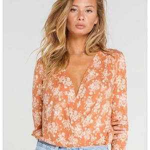 Free people turnt floral body suit in rust color